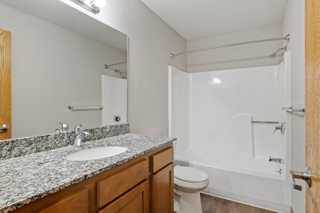 A bathroom with a sink, toilet, and bathtub.