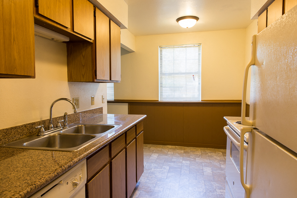 a kitchen with a sink and a refrigerator