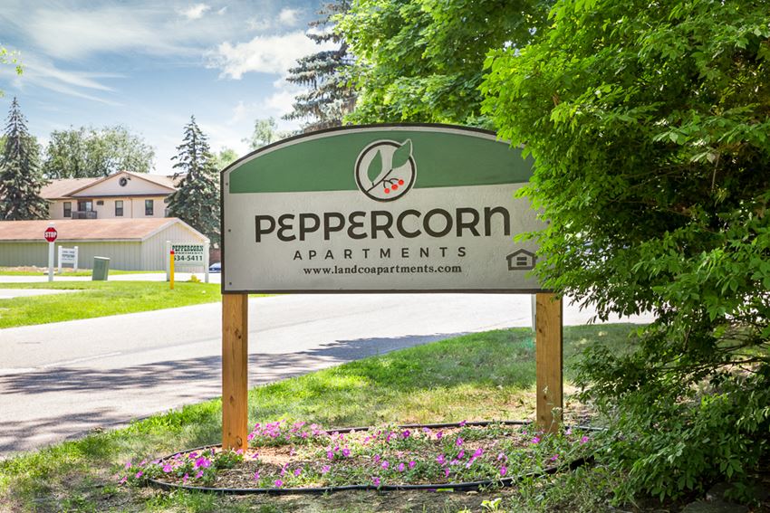 a sign that reads peppercoron apartments on the side of a road