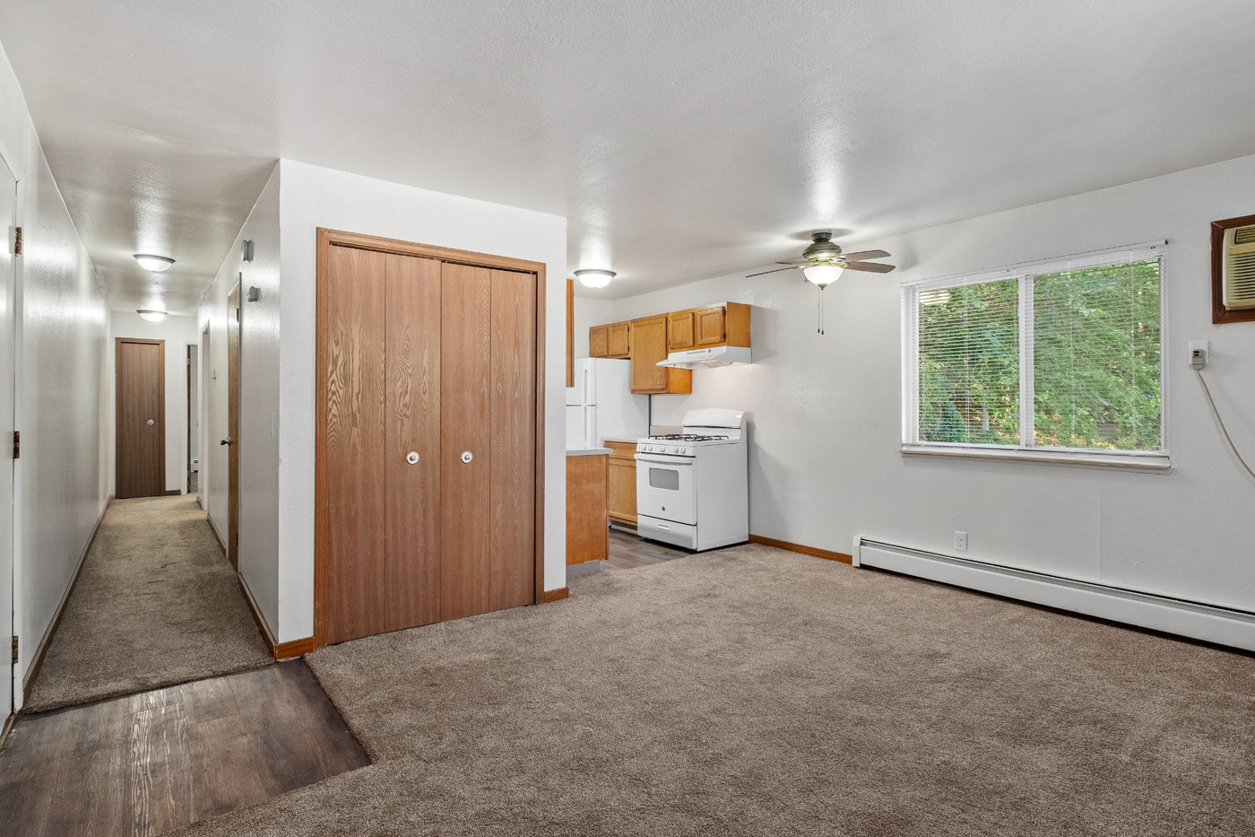 A room with a washing machine and a window.