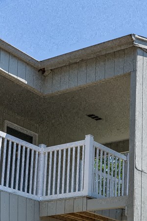 Prairie Creek Apartment Building Stairway a house with a porch and stairs on it