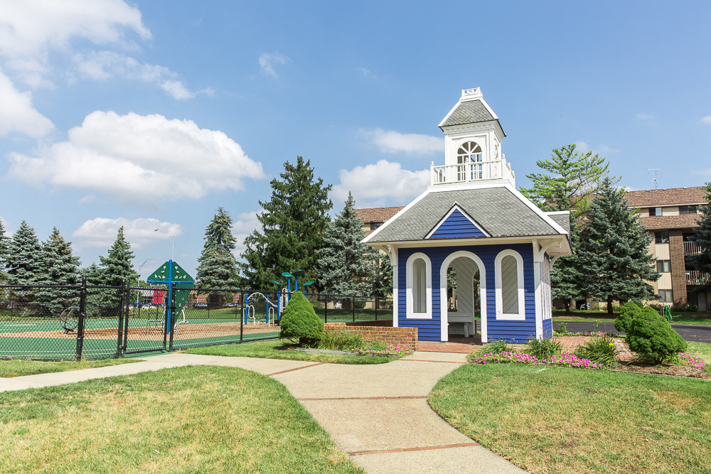 a small building with a clock tower on top of it
