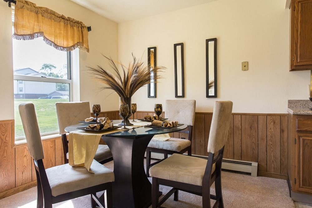 a dining room with a table and chairs