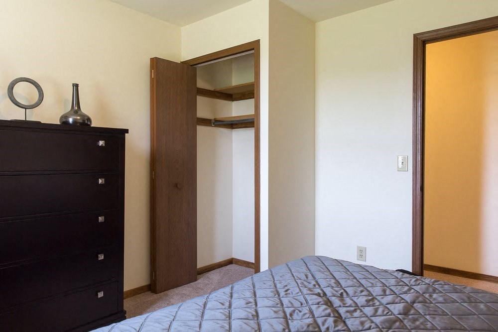 a bedroom with a bed and a closet