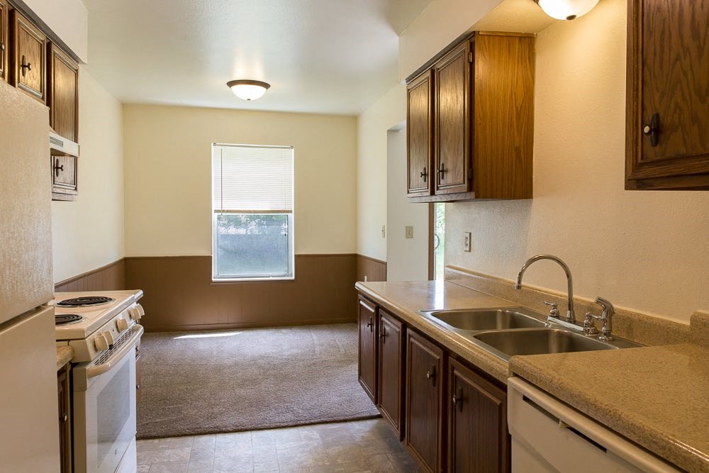 a kitchen with a sink and a stove and a window