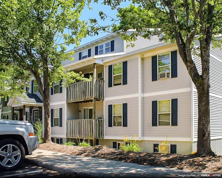 a white house with a truck parked in front of it