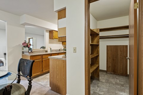 A kitchen with a chair and a table.