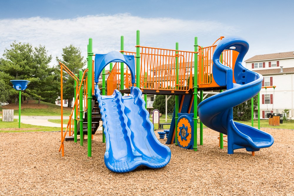 a playground with a slide at a park