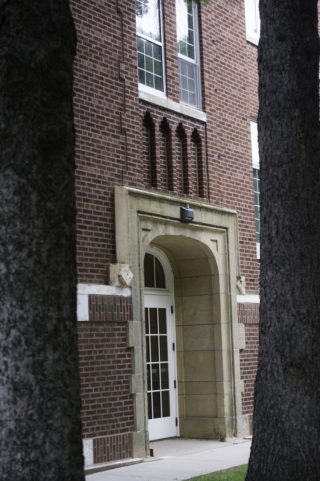 the entrance to a brick building with a white door