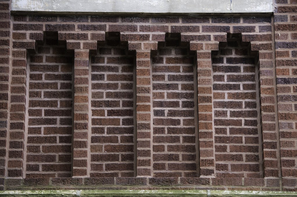 three windows in a brick wall