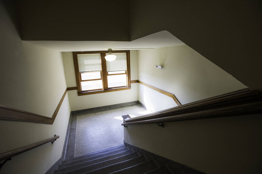 a stairway in a building with a window and stairs