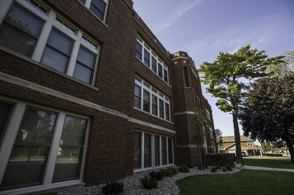 a brick building with a tree in front of it