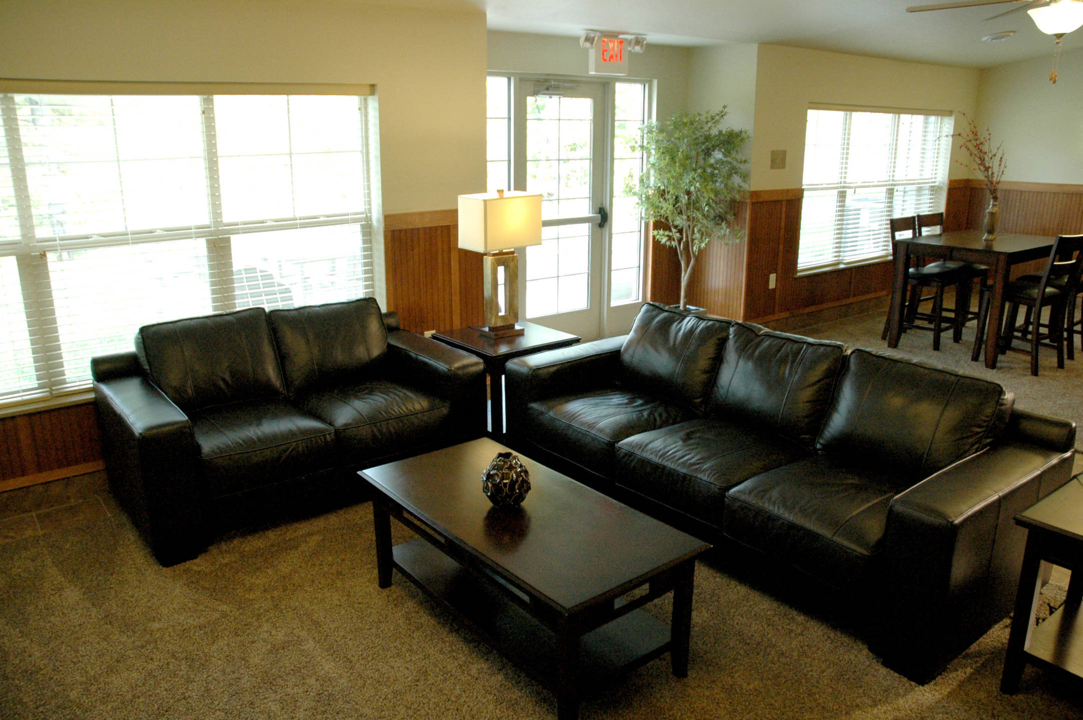 a living room with leather couches and a coffee table