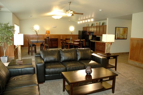 a living room with leather couches and a table