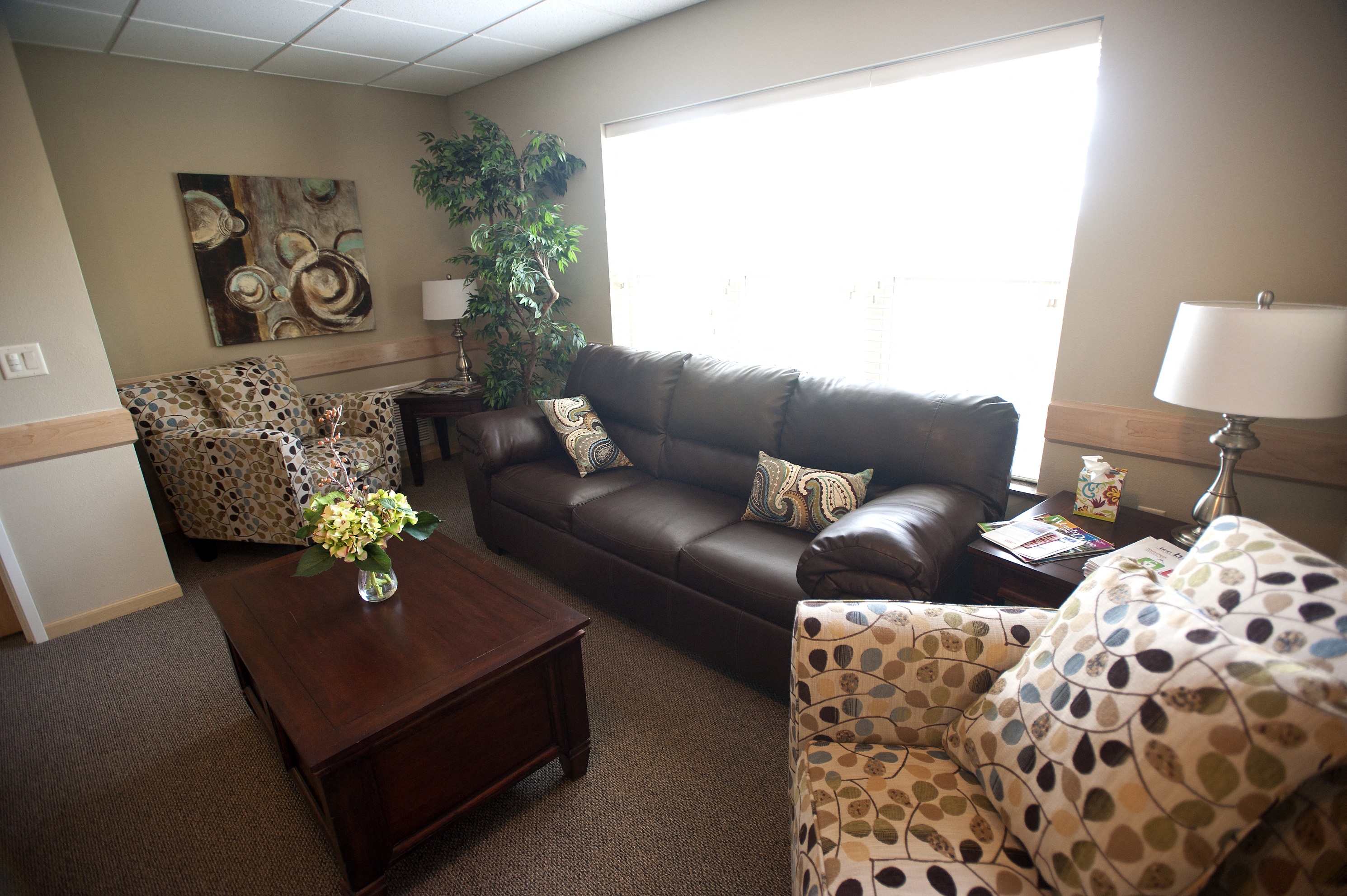 a living room with leather furniture and a window
