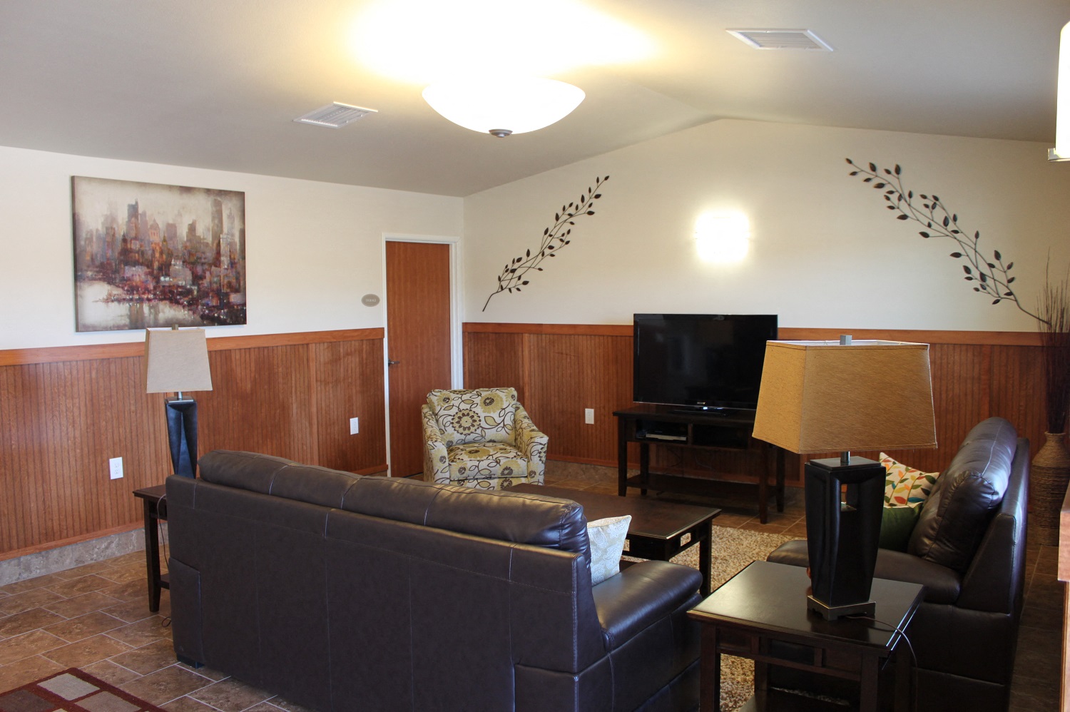 a living room with leather couches and a television