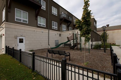 an outdoor playground in front of an apartment building