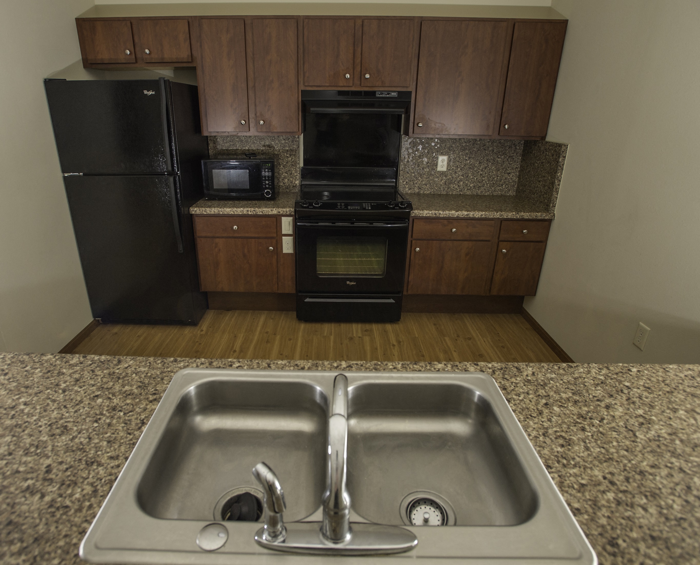 a kitchen with a sink and a stove and a refrigerator