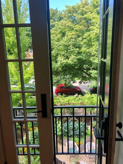 a view of a balcony with a red car