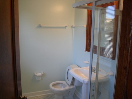 a bathroom with a toilet sink and a mirror