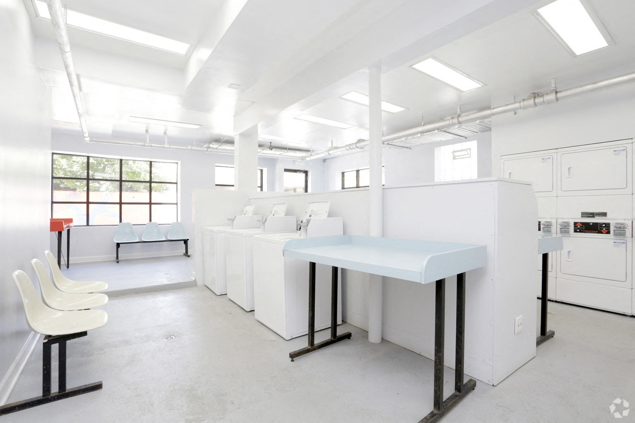 a white laboratory with white desks and chairs and white cabinets