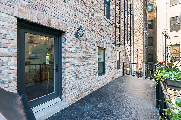 the entrance to a brick building with a black door