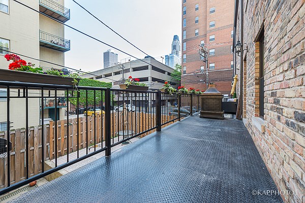 a balcony with a fence and a city in the background