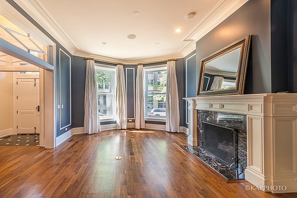 a living room with a fireplace and blue walls