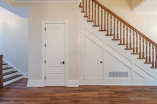 a staircase in a house with a white door and stairs
