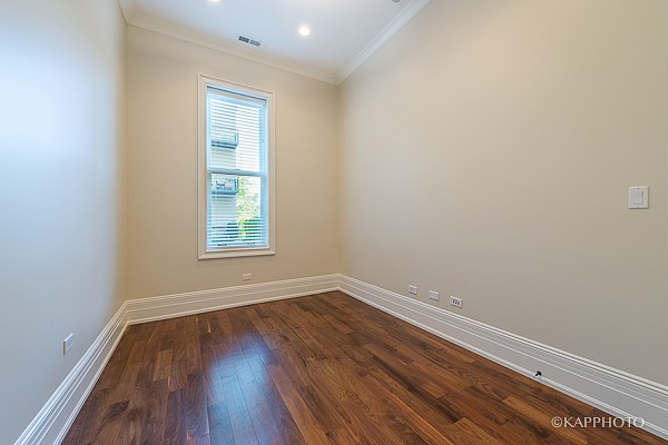 a living room with wood floors and a window