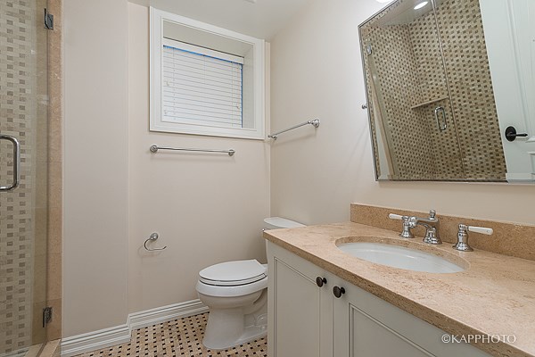 a bathroom with a sink toilet and a shower