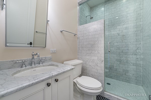 a bathroom with a sink toilet and a shower