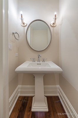 a small bathroom with a white sink and a mirror