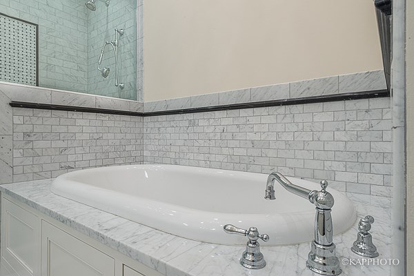 a bathroom with a bath tub and a mirror