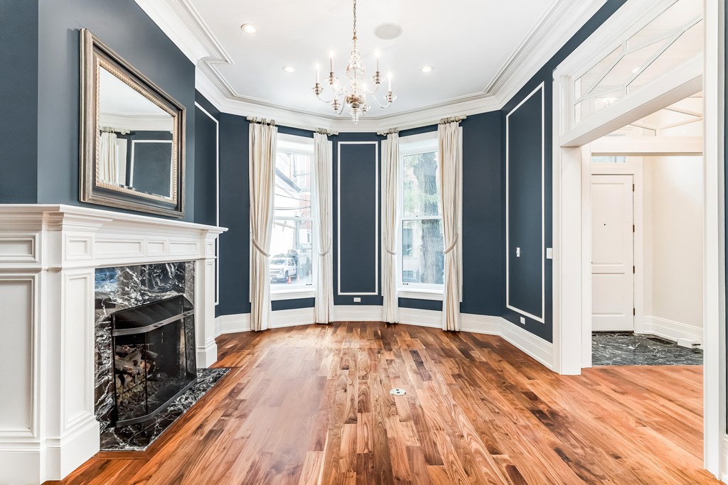 a living room with blue walls and a fireplace