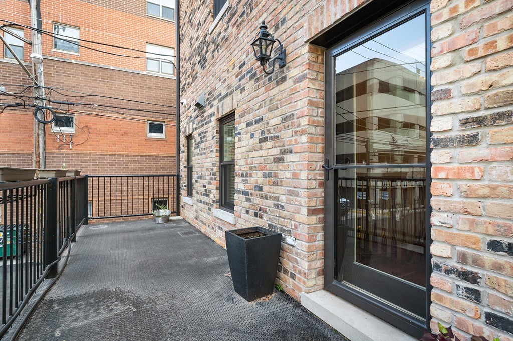 the entrance to a brick building with a large glass door