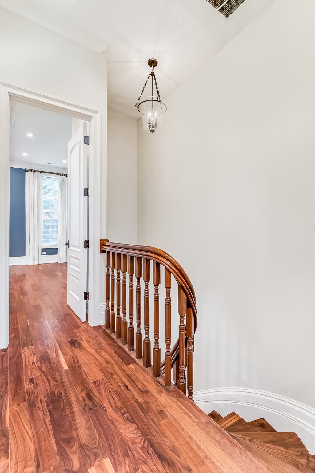 a view of the top of a wooden staircase in a home with a wood floor