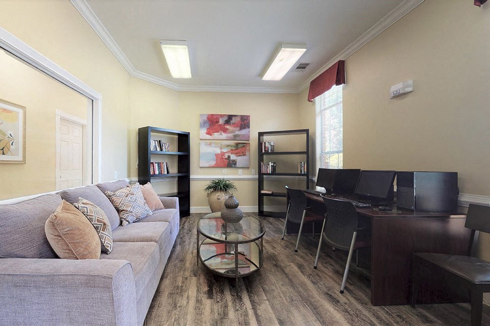 a living room with a couch and a desk
