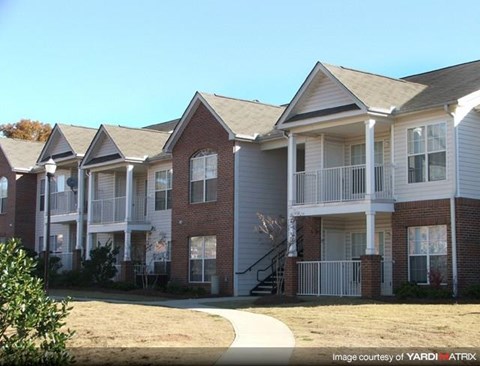Apartment complex with a clear blue sky above.
