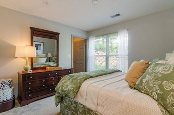 Large bedrooms with view of complex at Villiages of Carver in Atlanta, Georgia