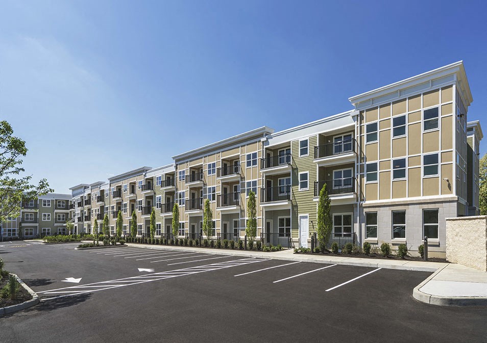 a parking lot in front of an apartment building