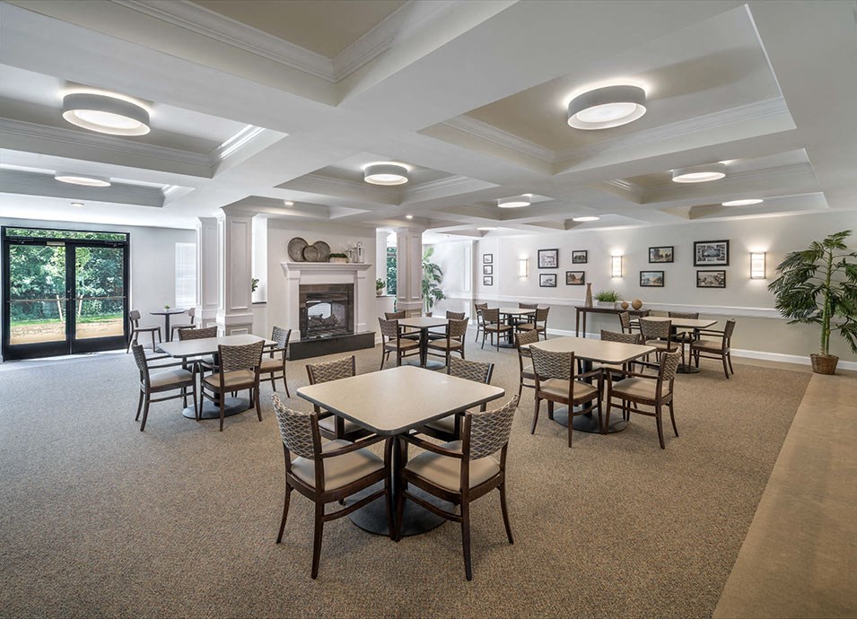 a conference room with tables and chairs and a fireplace