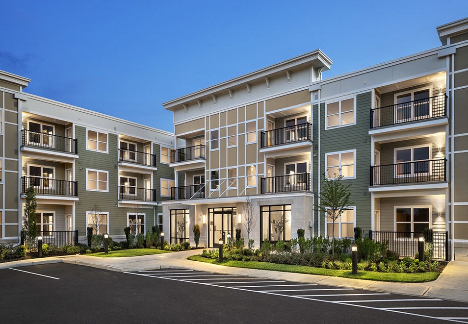 an exterior view of an apartment building at dusk