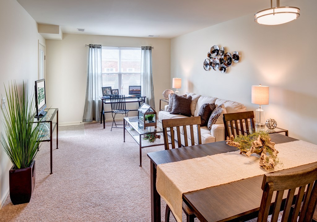 a living room and dining room with a couch and a table