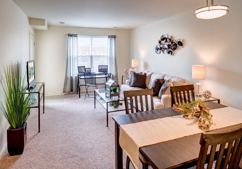 a living room and dining room with a couch and a table