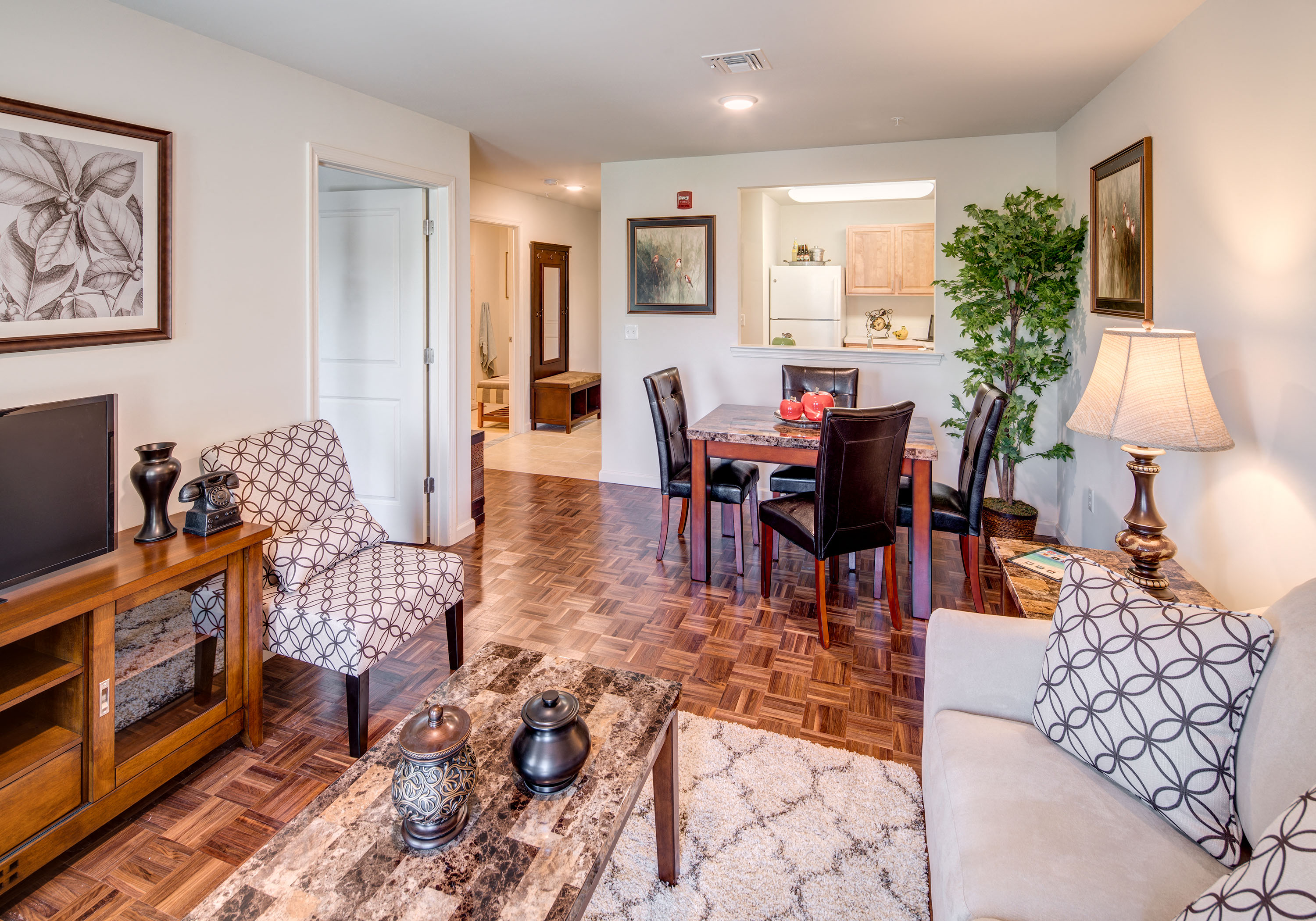 the living room and dining room of a house with a table and chairs