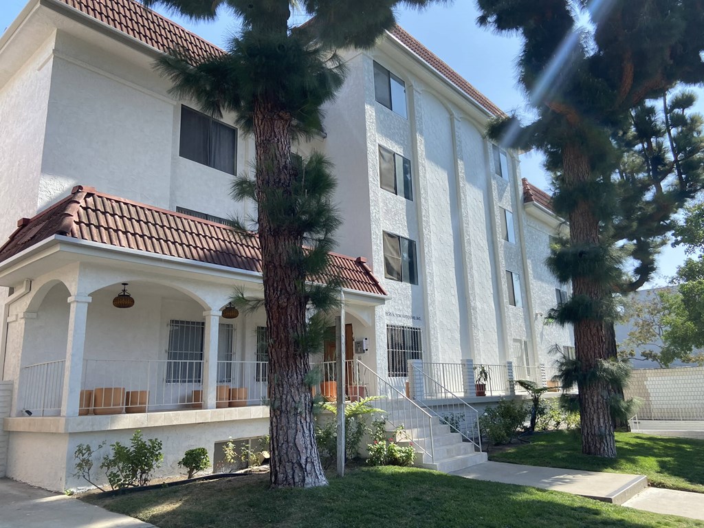 a building with two palm trees in front of it
