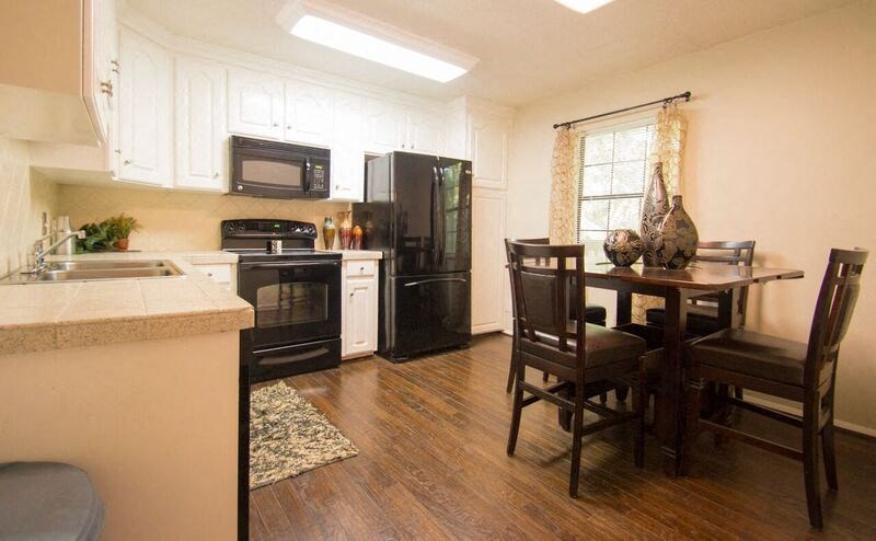 a kitchen with a table and chairs