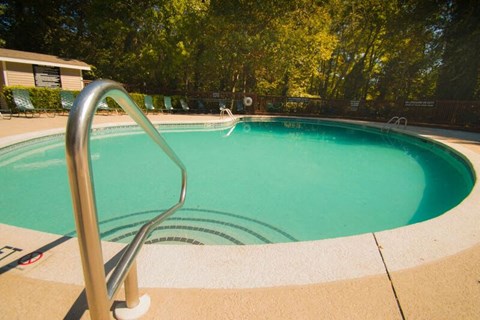 a swimming pool with a metal fence around it