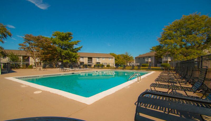 a swimming pool with chairs around it